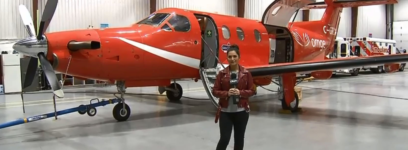Stella Acquisto in front of fixed wing aircraft