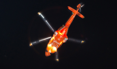 belly of ornge helicopter in night sky
