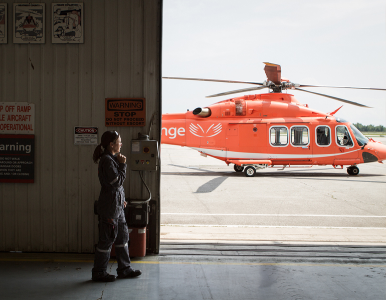 An image of an Ornge employee working in the corporate sector wearing a headset