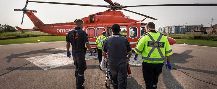 two Ornge paramedics boarding an Ornge helicopter