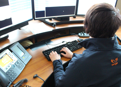 A woman working in operations with a headset on