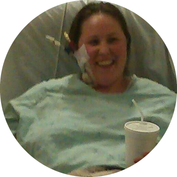 Annie sitting in a hospital with medical equipment.