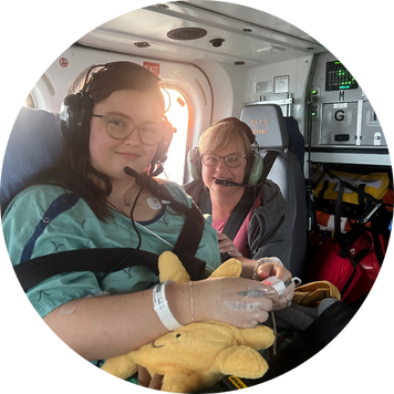 emma and her mom inside a helicopter that has medical equipment