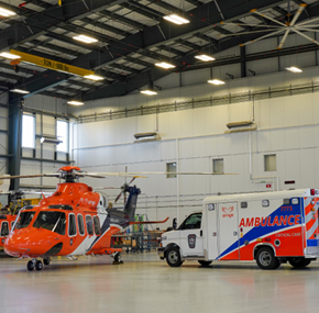An Ornge ambulance and helicopter in the hangar