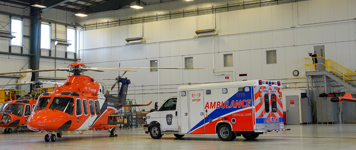 An Ornge ambulance and helicopter in the hangar