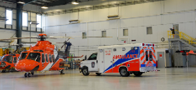 An Ornge ambulance and helicopter in the hangar
