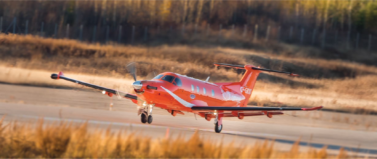 orange plane landing on a runway
