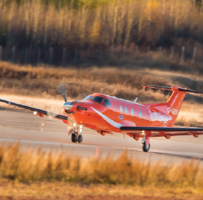 orange plane landing on a runway