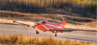 orange plane landing on a runway