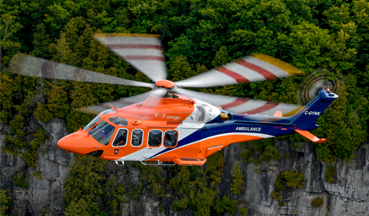 Leonardo AW139 flying over a forested area