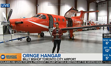 Stella Acquisto in front of fixed wing aircraft