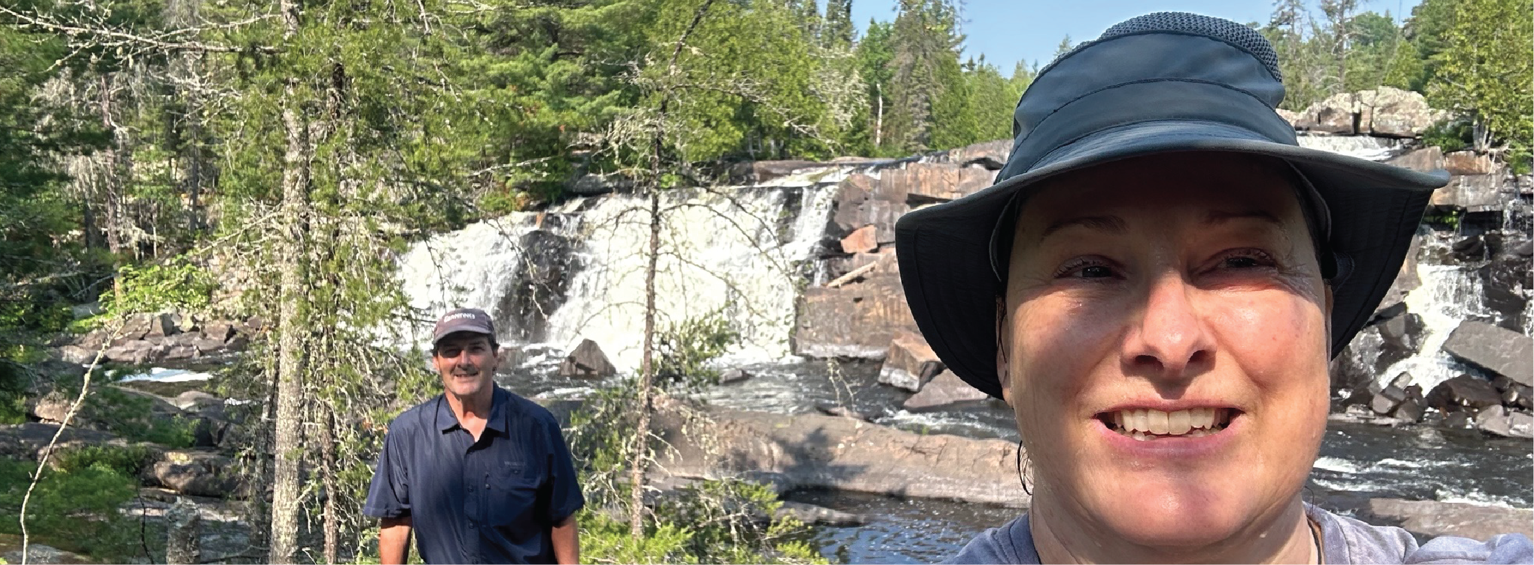 Two people taking a selfie in a forested area