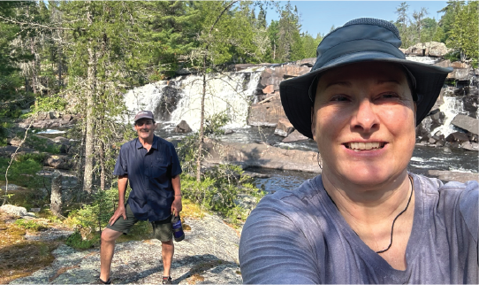 Two people taking a selfie in a forested area