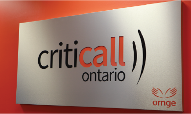 A rectangular sign mounted on a orange wall displaying the logo for CritiCall Ontario. The text reads “criticall ontario”