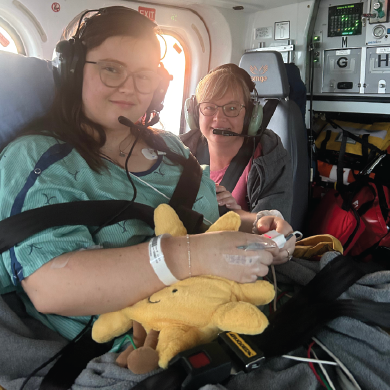 Emma and her mom in the back of an helicopter