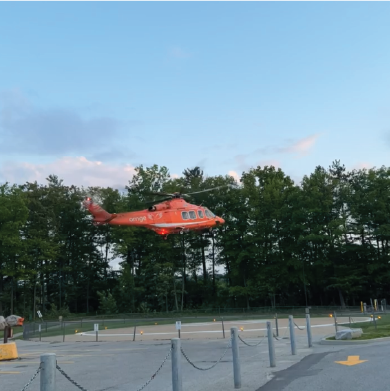 an orange helicopter taking off
