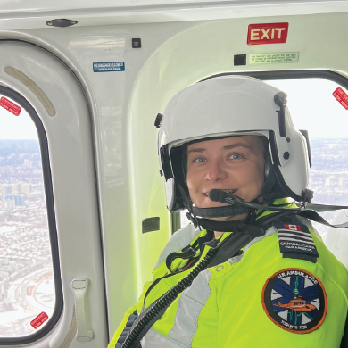 A paramedic in uniform in a helicopter