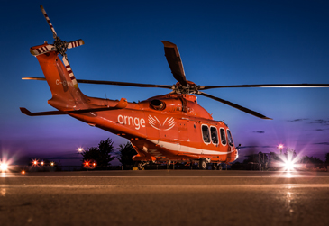An image of an Ornge helicopter landed in an Ornge base garage