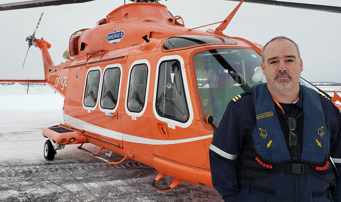 Liam Dowd standing in front of a rotor wing