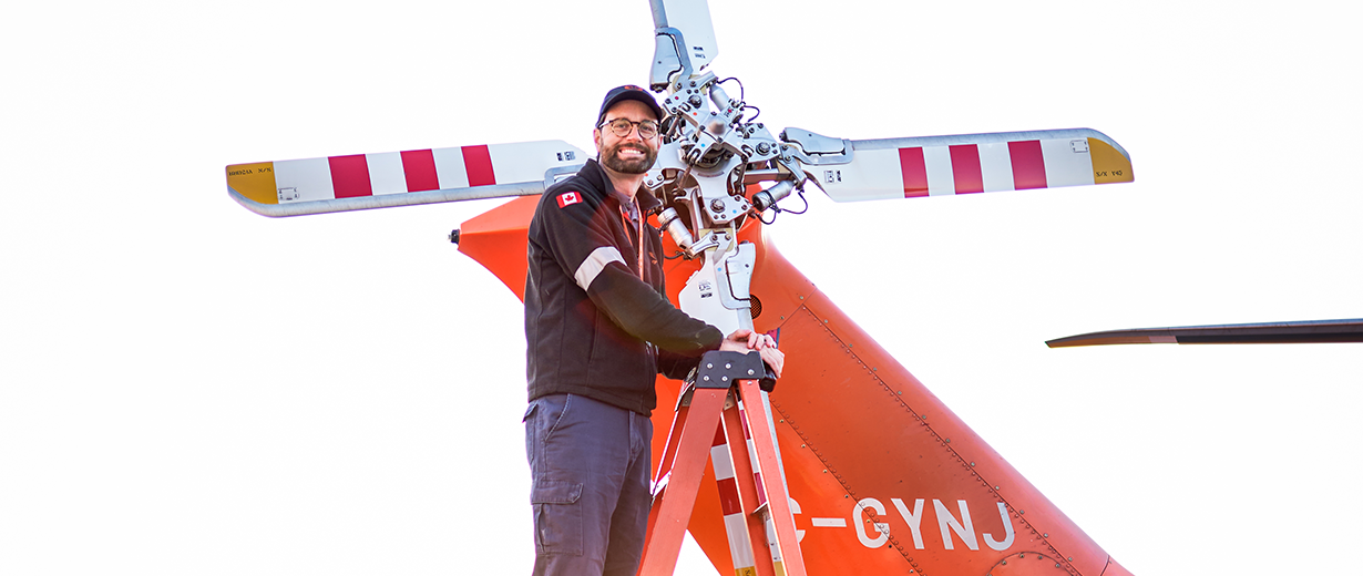 A picture of Jason Hick AME working on the tail rotor of an Ornge helicopter