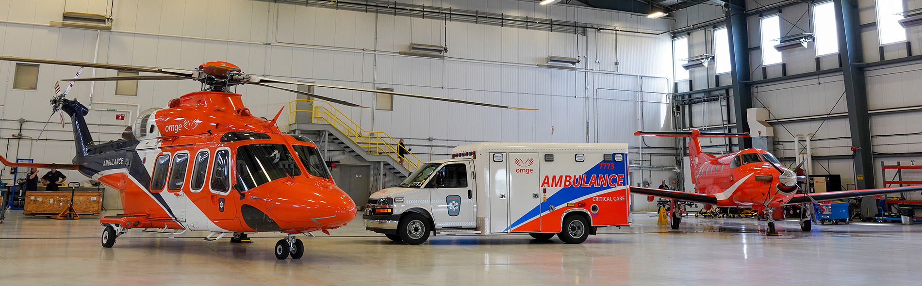 an Ornge helicopter, land ambulance, and plane
