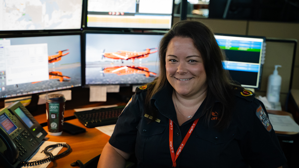 Lisa Ratledge sitting down and smiling in front of desktop station