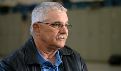 Tom McEwen in blue shirt and black jacket