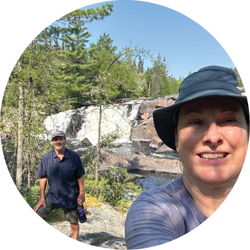 Two people taking a selfie in a forested area